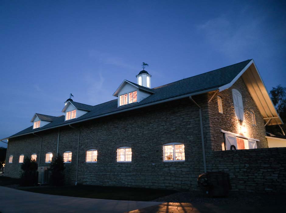 Mayowood Stone Barn wedding and event venue in Rochester MN lit up at night
