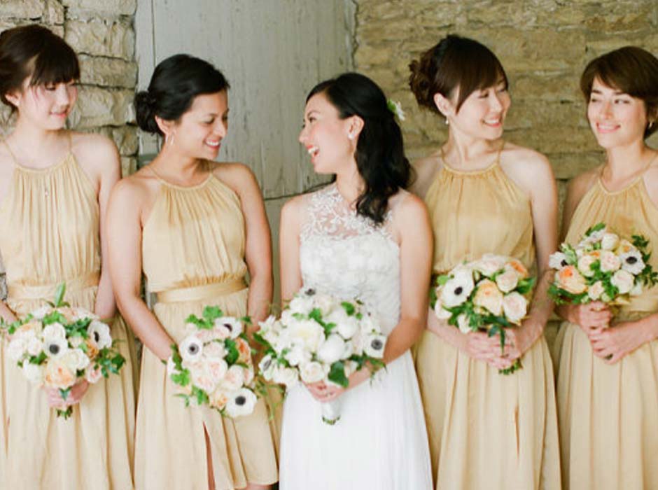 Bridesmaids hold bouquets at Mayowood Stone Barn Rochester MN wedding event venue